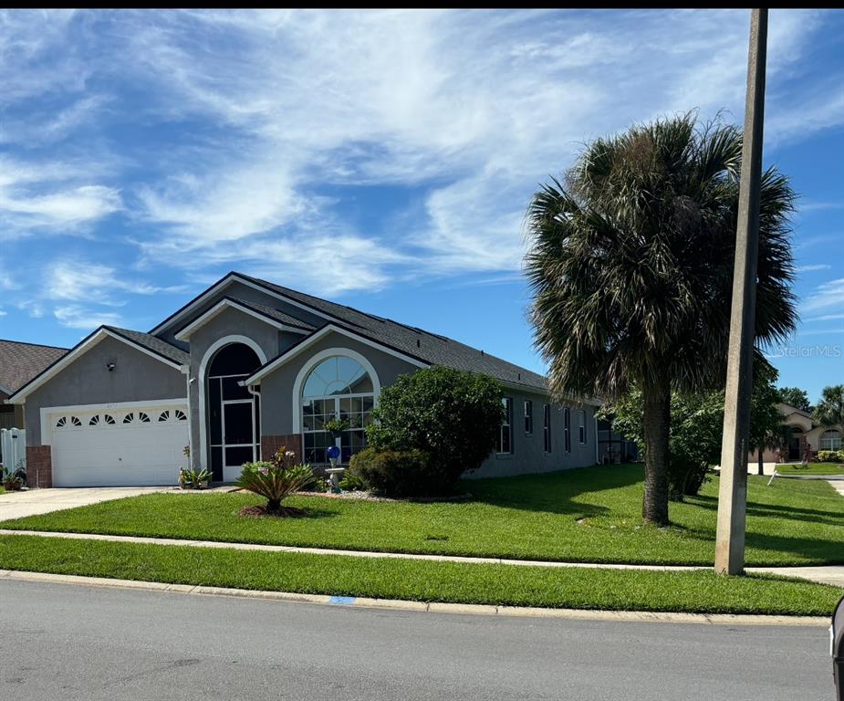 a front view of a house with a garden