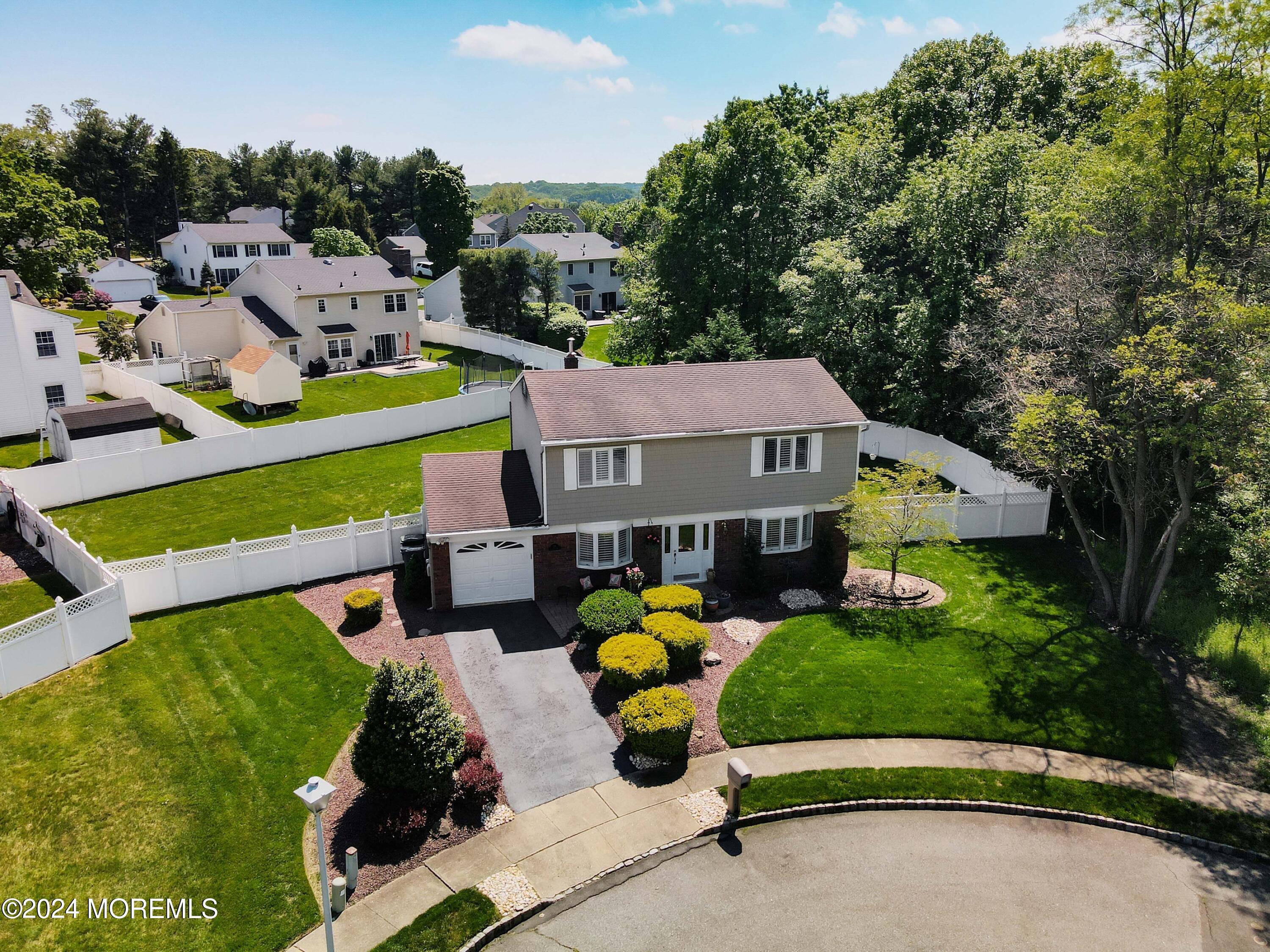 an aerial view of a house with swimming pool garden and patio