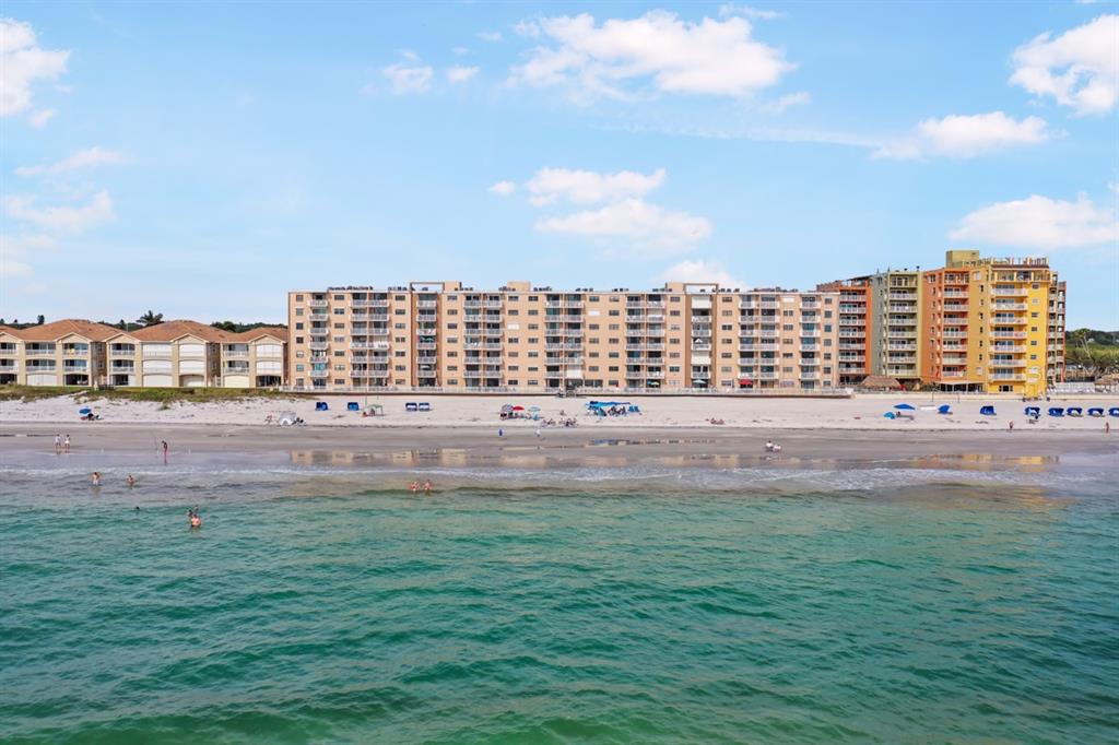 a view of building with outdoor space and ocean view