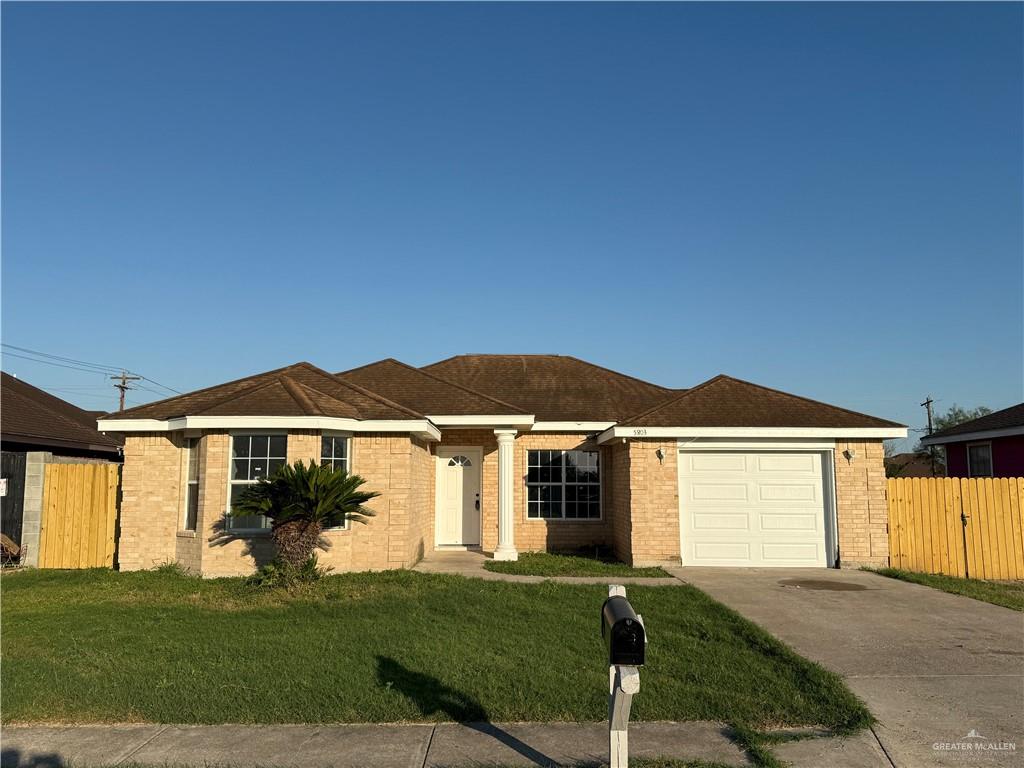 Ranch-style house with a front lawn and a garage