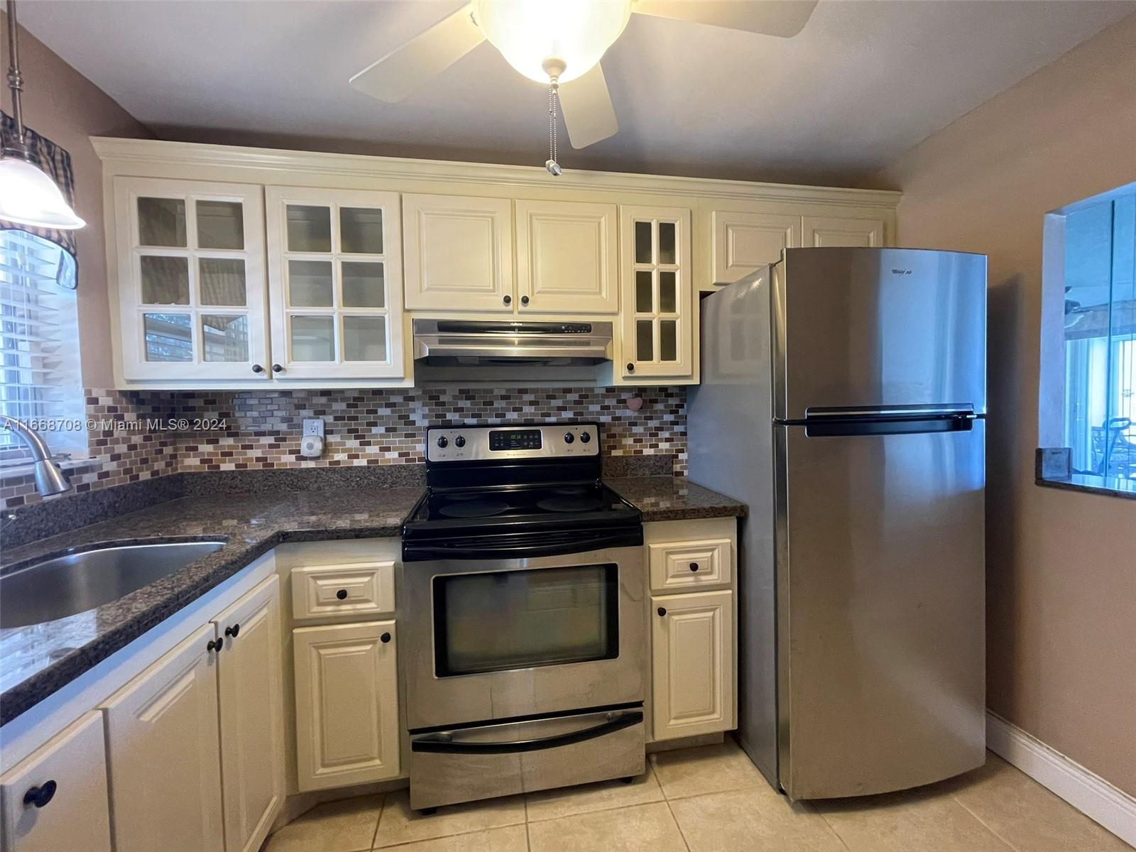 a kitchen with a refrigerator stove and sink