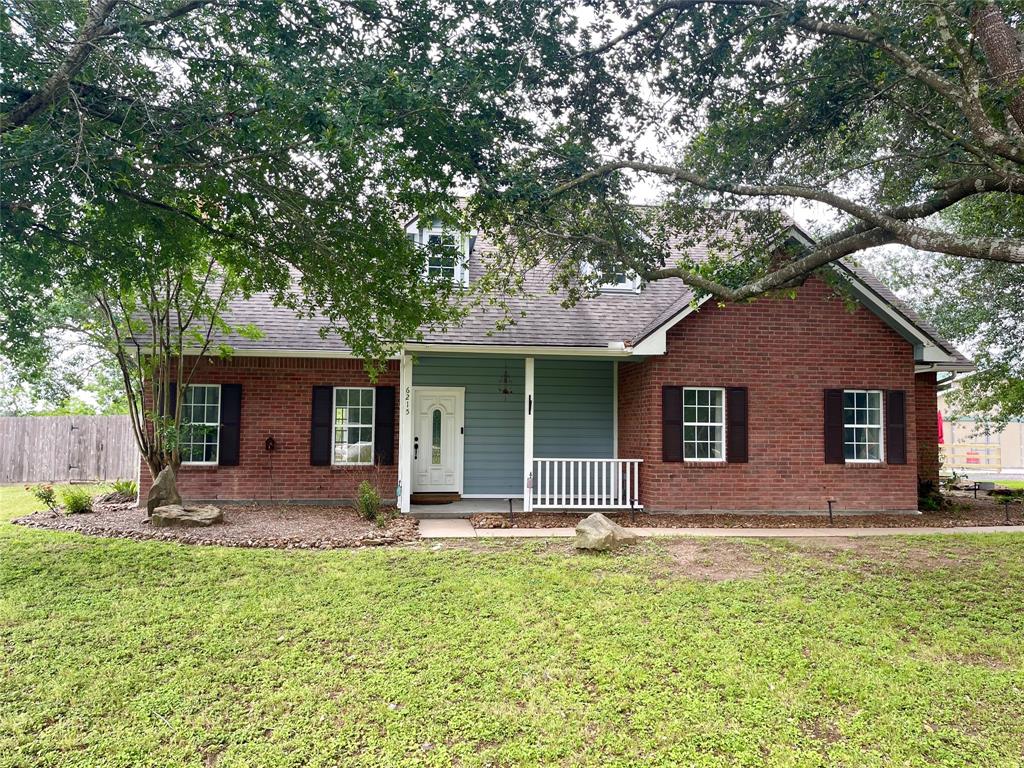 a front view of house with yard and outdoor seating