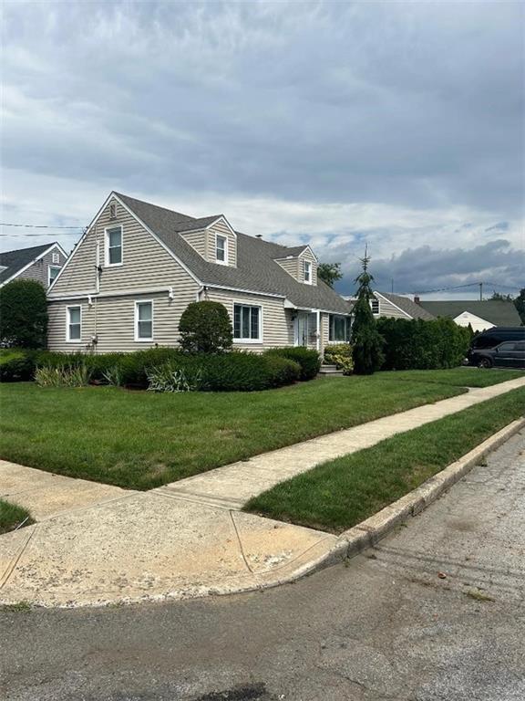 a front view of house with yard and green space