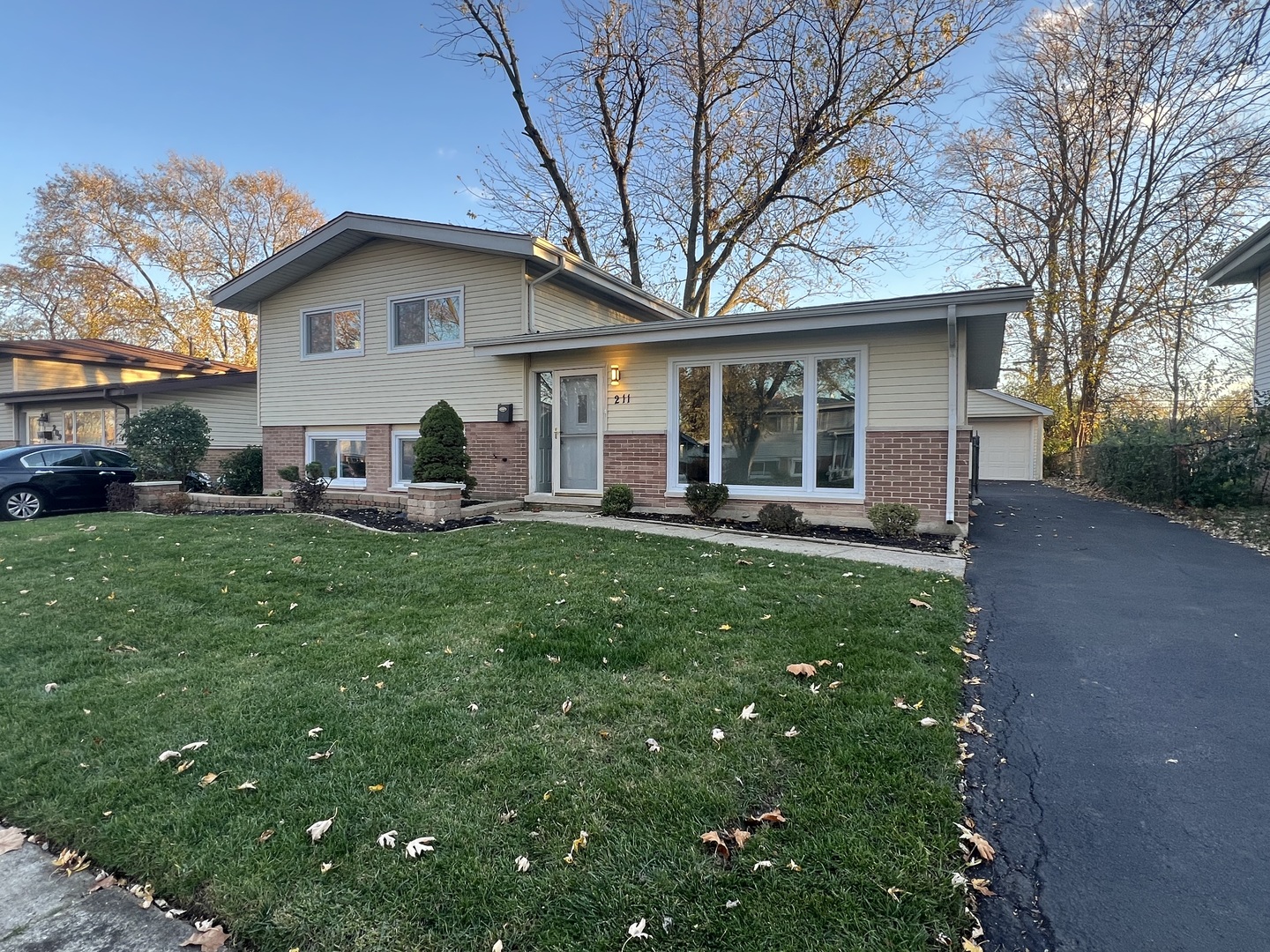 a front view of house with yard and green space