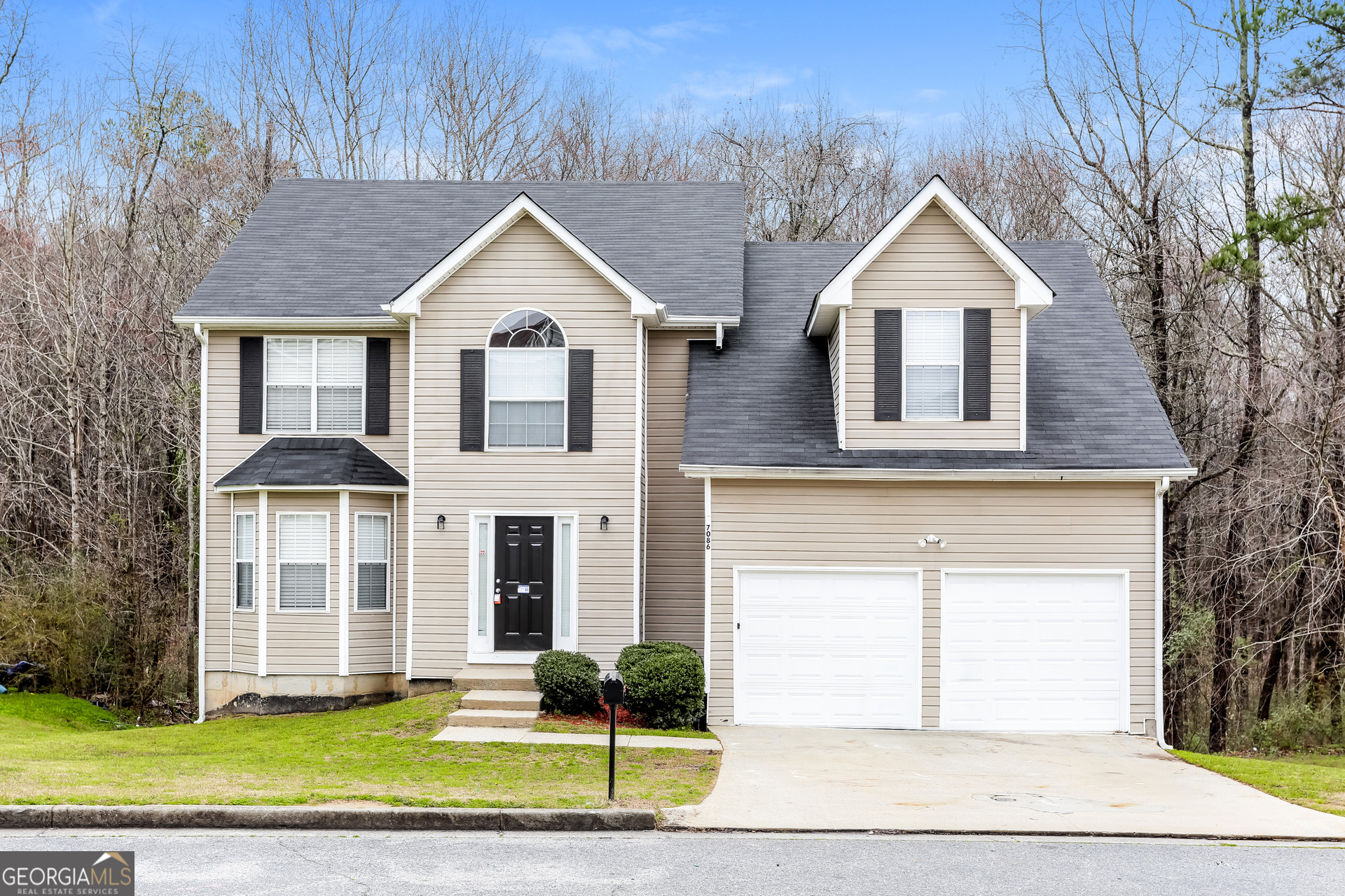 a front view of a house with a yard