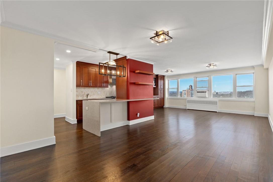 a view of a kitchen with furniture and wooden floor