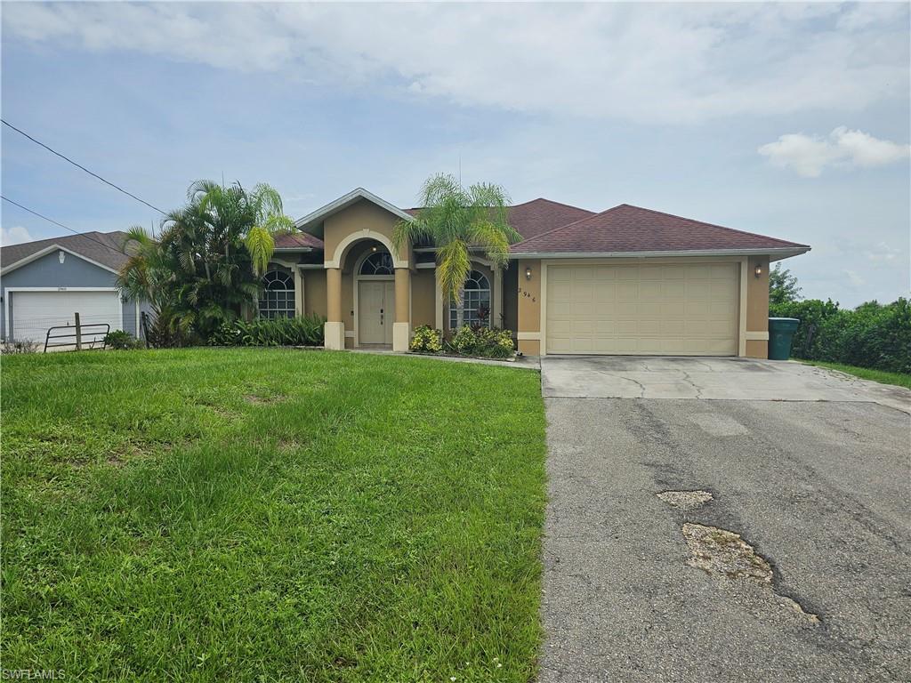 a front view of a house with yard and green space