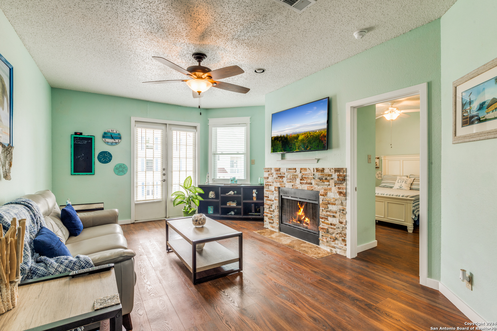 a living room with furniture a fireplace and a flat screen tv