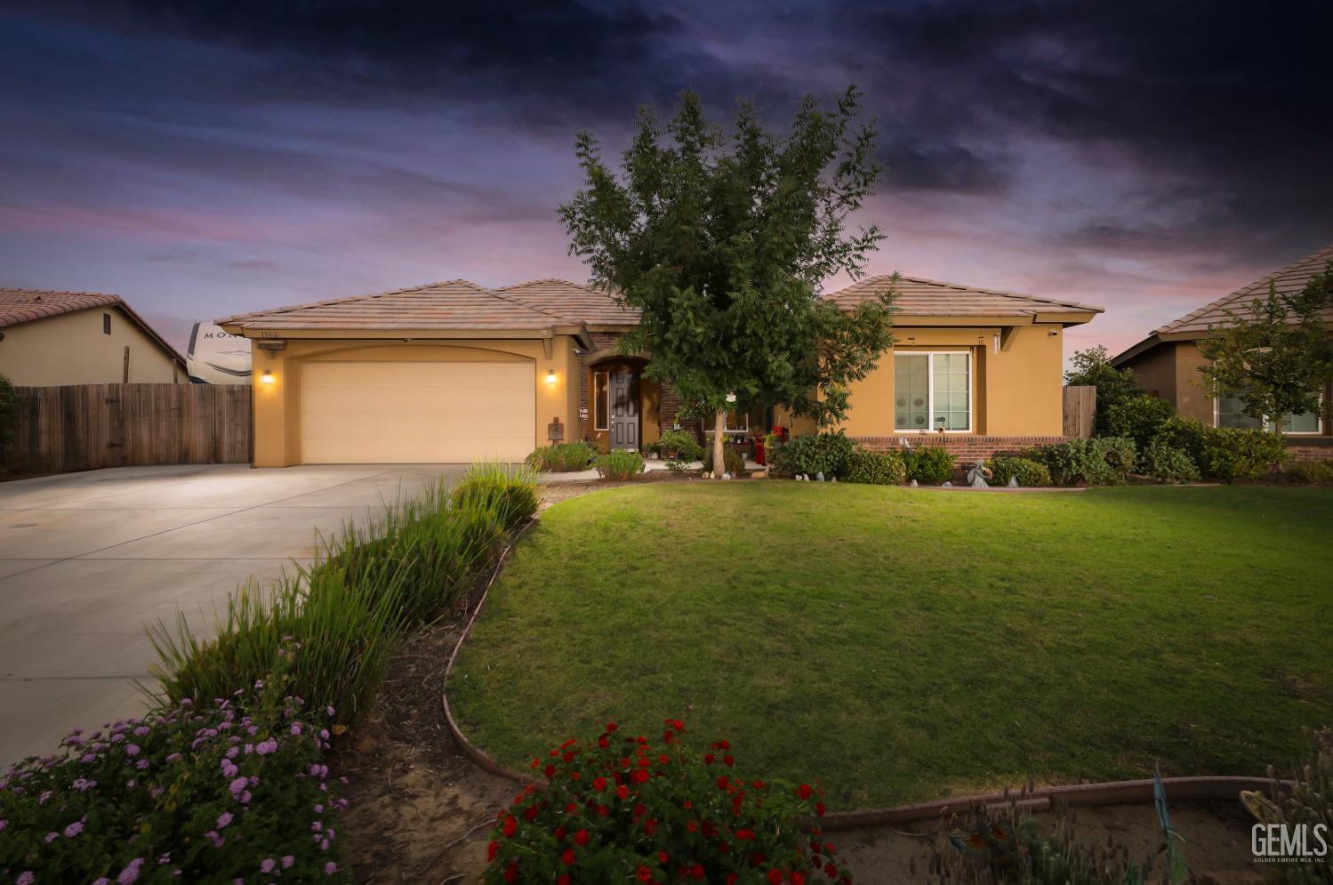 a view of a house with a big yard and potted plants