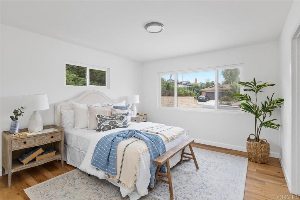 a bedroom with a bed and a potted plant