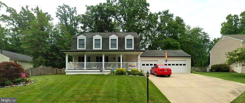 a front view of a house with a yard and a garage