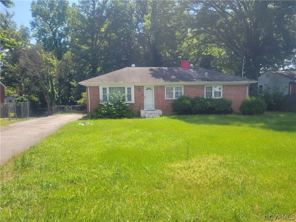 a front view of a house with yard and green space