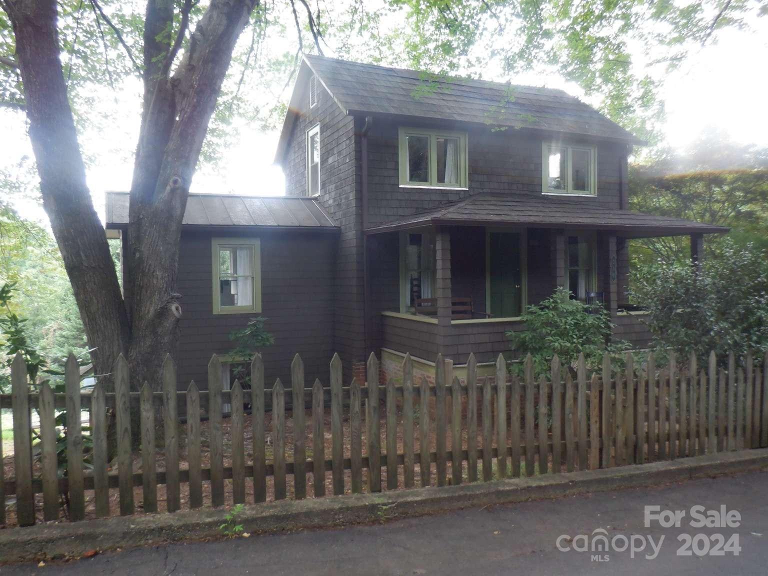 a front view of house with a garden