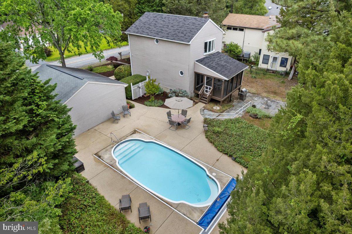 a aerial view of a house with swimming pool and big yard