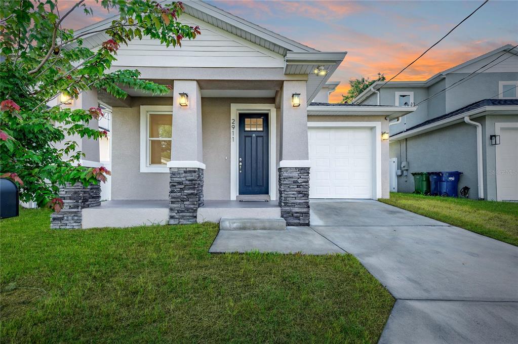 a front view of a house with a yard and garage