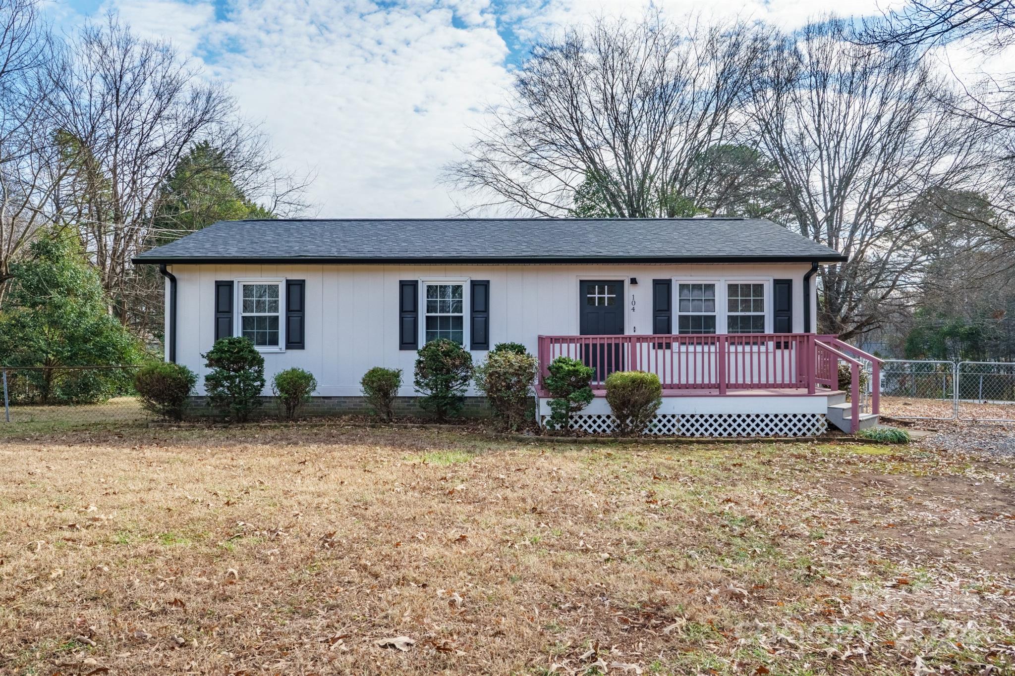 a view of a house with backyard and porch