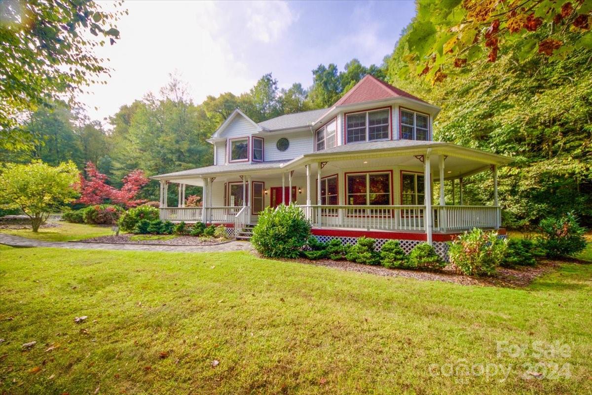 a front view of house with yard and green space