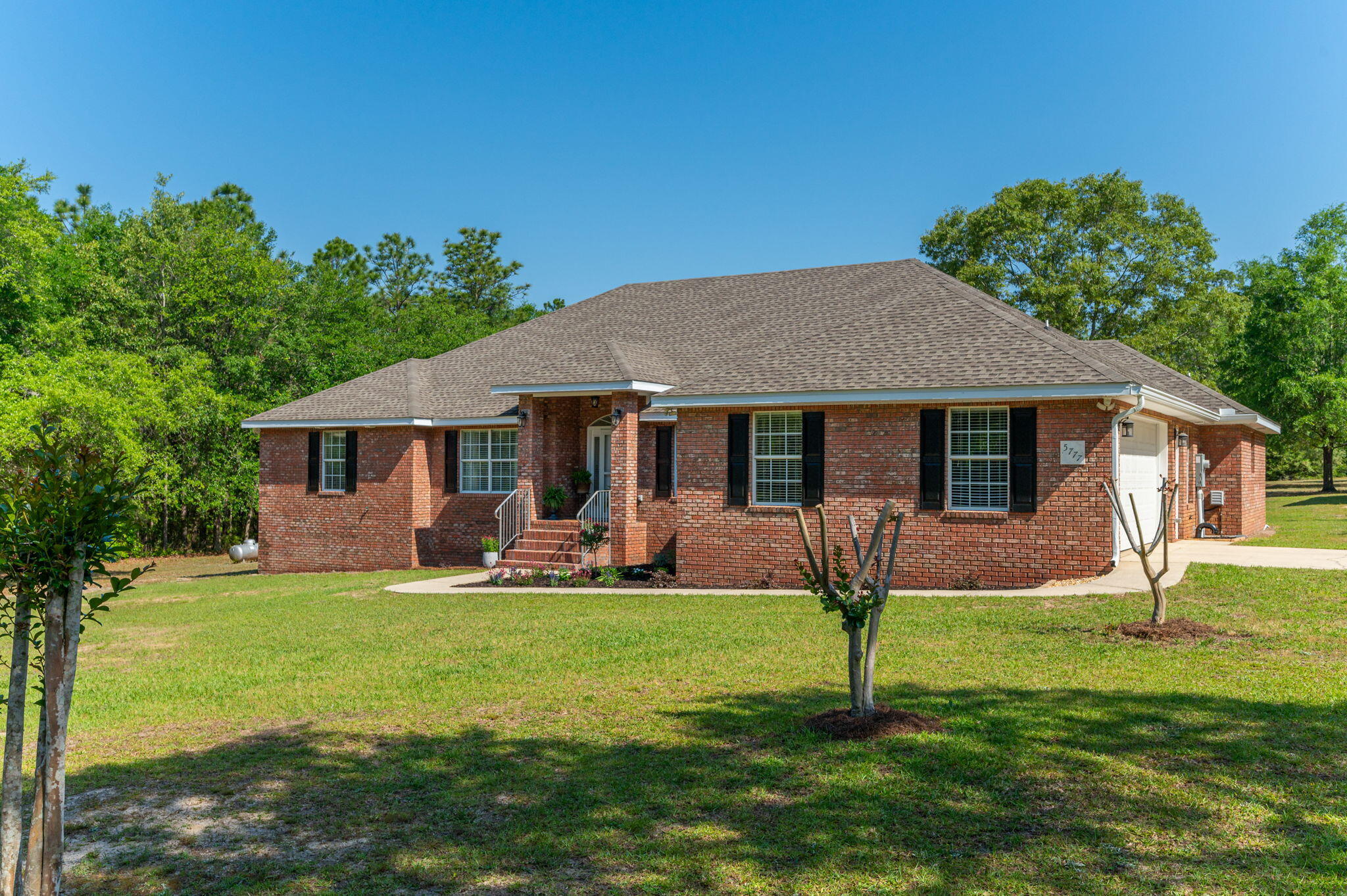 a front view of a house with a yard and porch