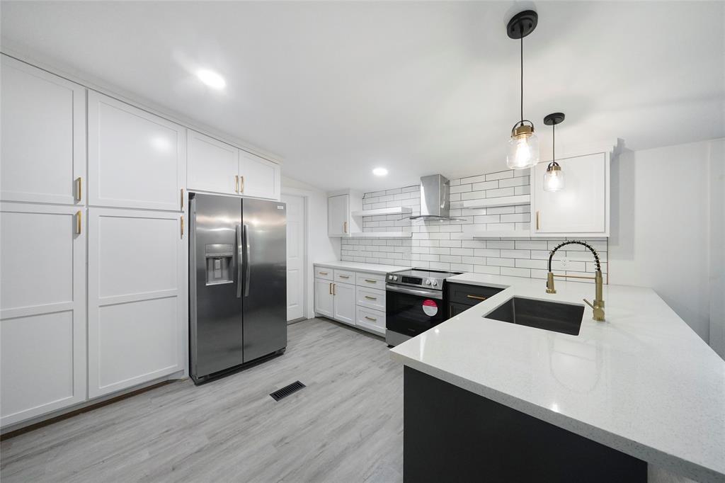 Remodeled from floor to ceilings... Spacious pantry storage, Quartz countertops, a new Refrigerator...Lots of elbow room for the new Chef...and Light & Bright...