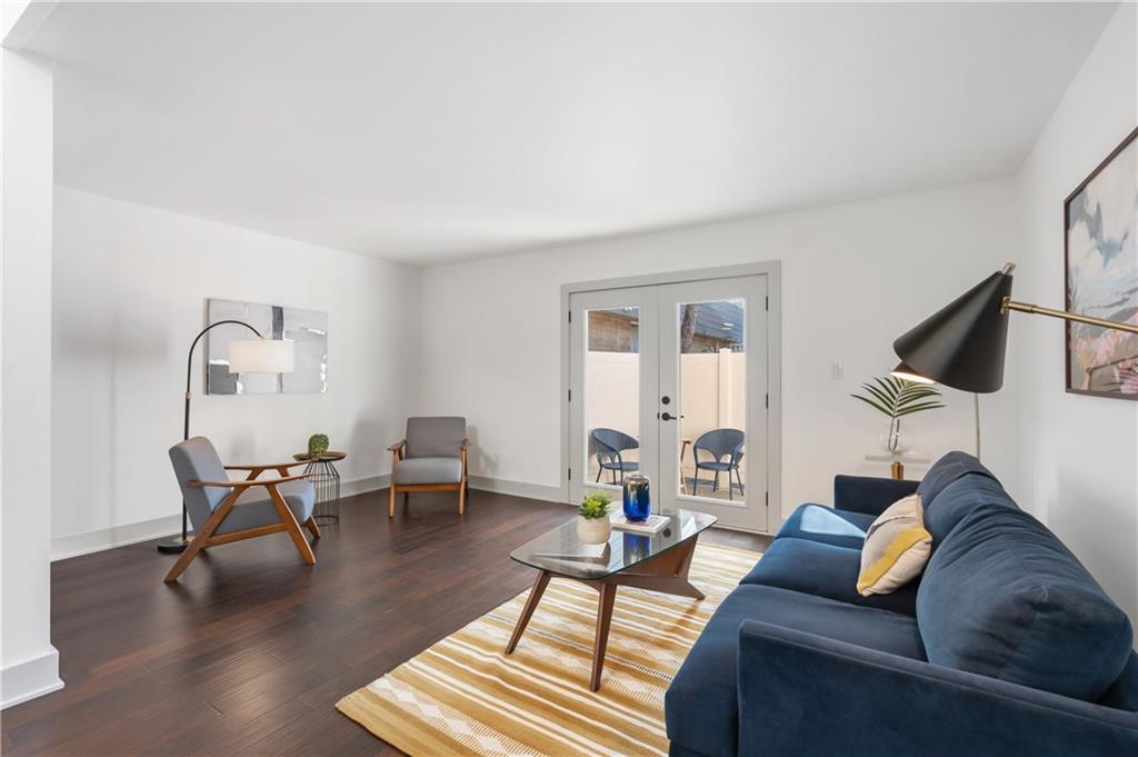 a living room with furniture and a wooden floor