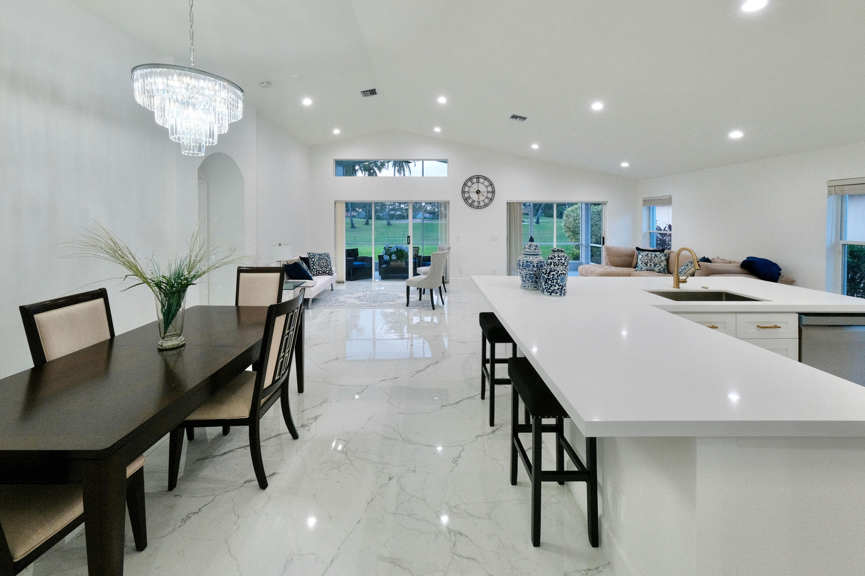 a view of a dining room with furniture and chandelier