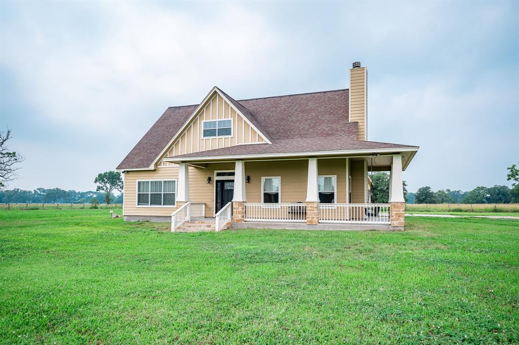 a front view of a house with a yard and sitting area