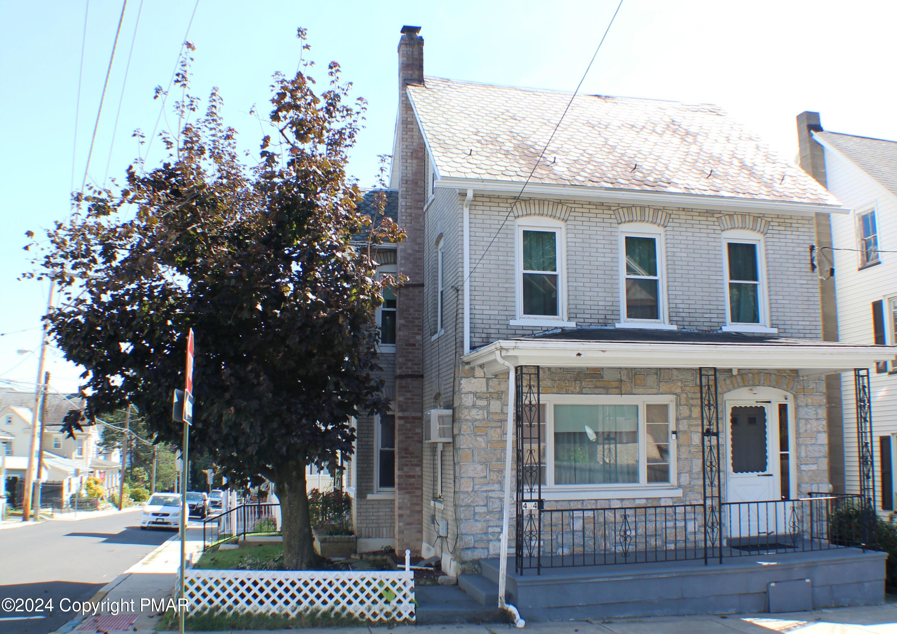 a view of a brick house with a yard