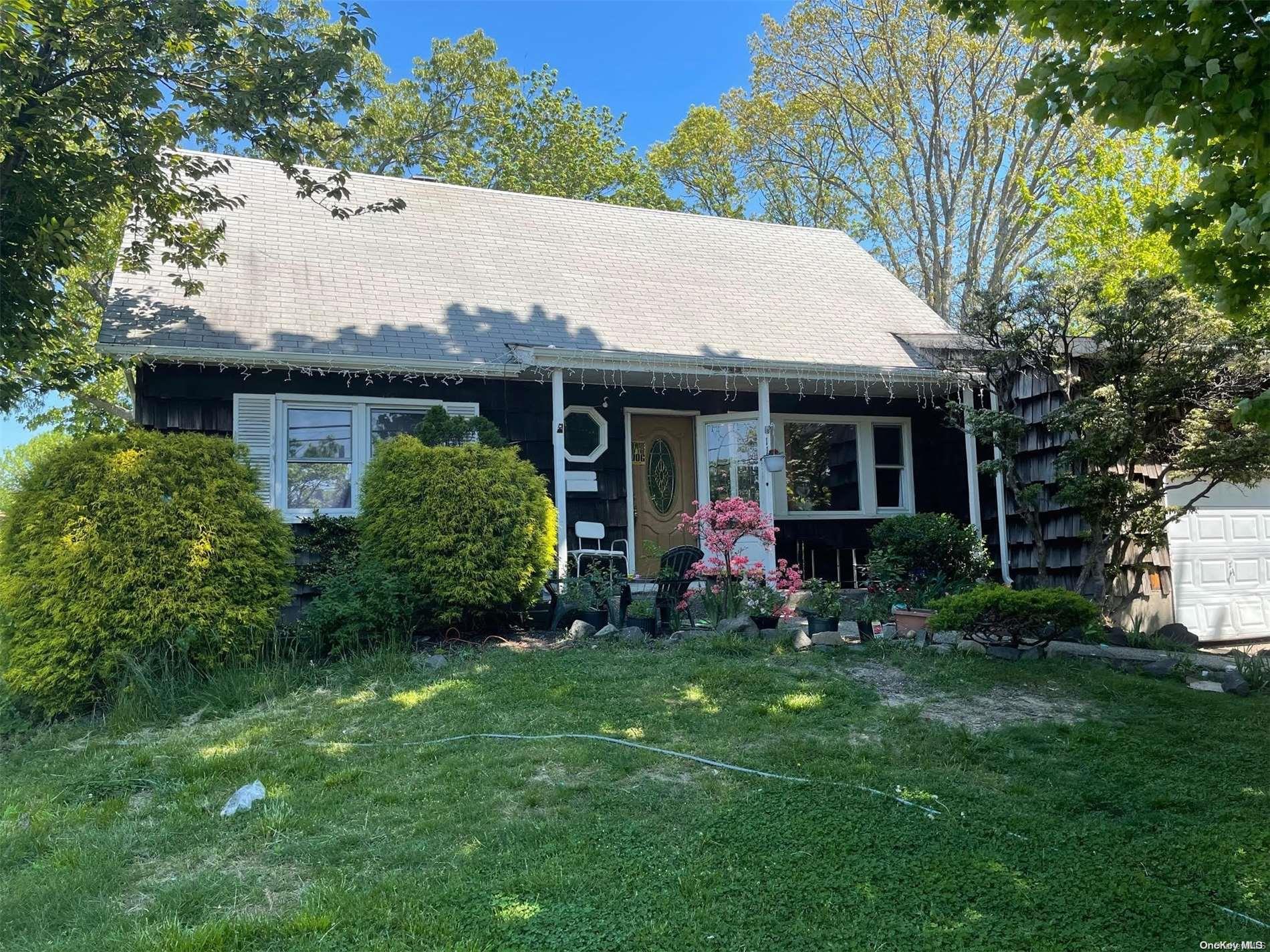 a front view of house with a garden and porch