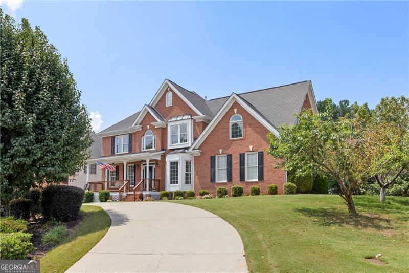 a front view of a house with a yard