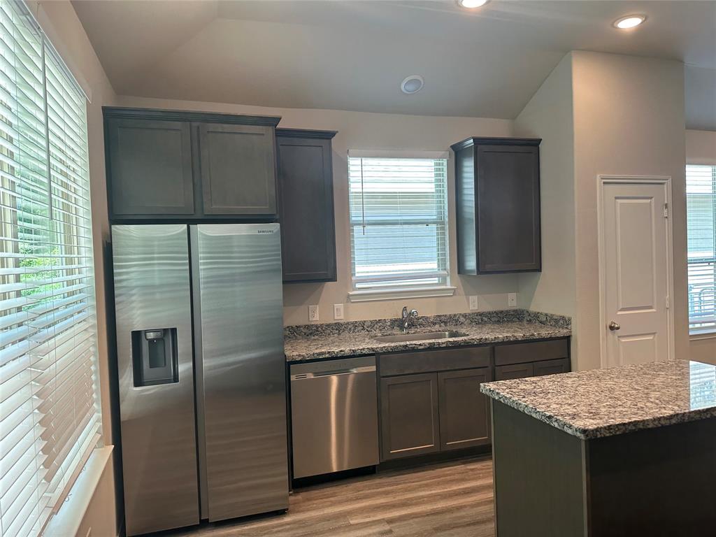 a kitchen with a sink stove and refrigerator