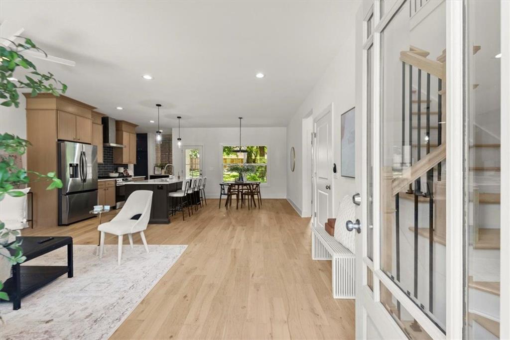 a view of a kitchen with furniture and wooden floor