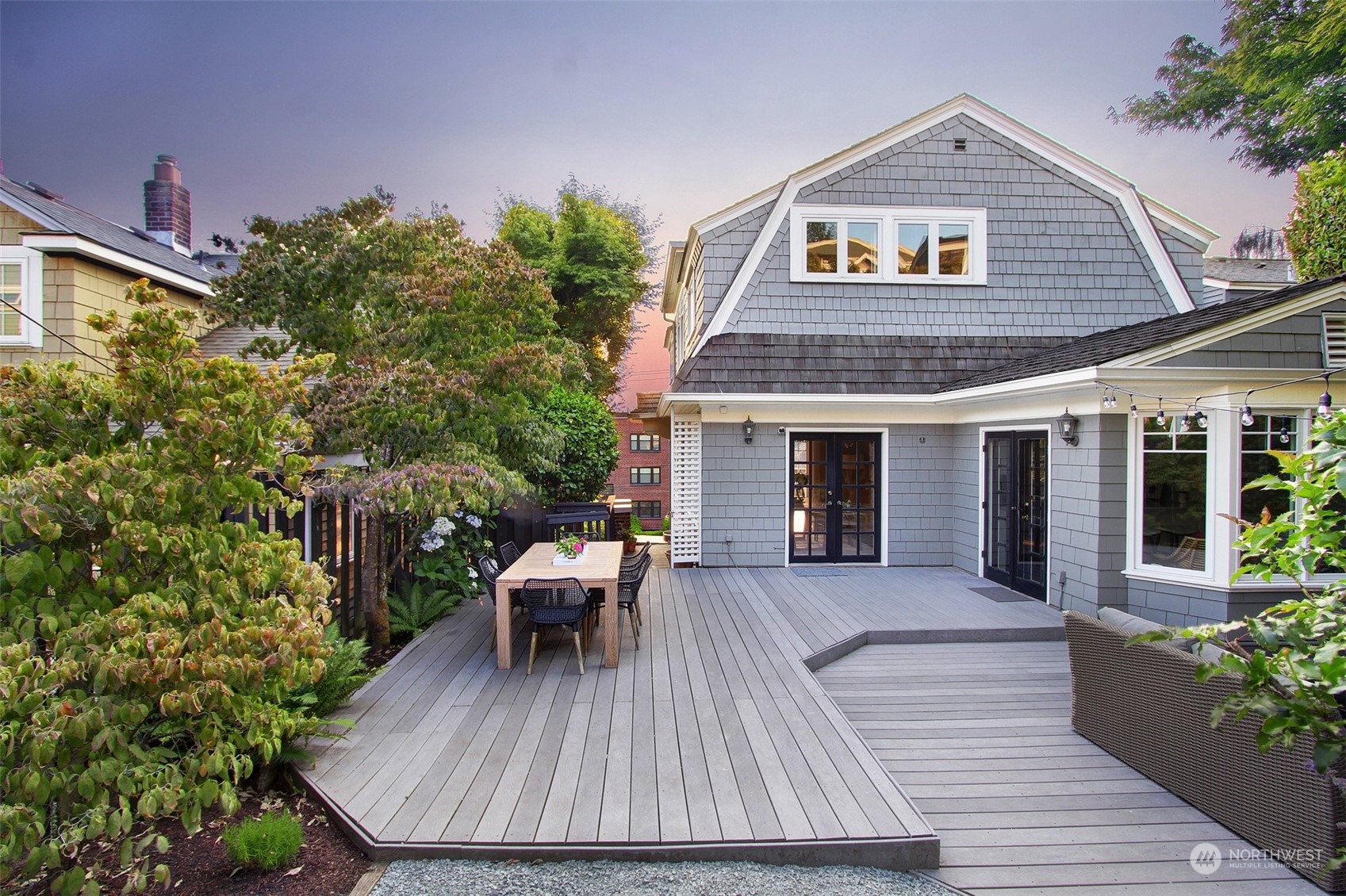 a view of house with deck and outdoor seating