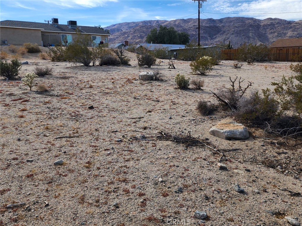 a view of a dry yard with a barn