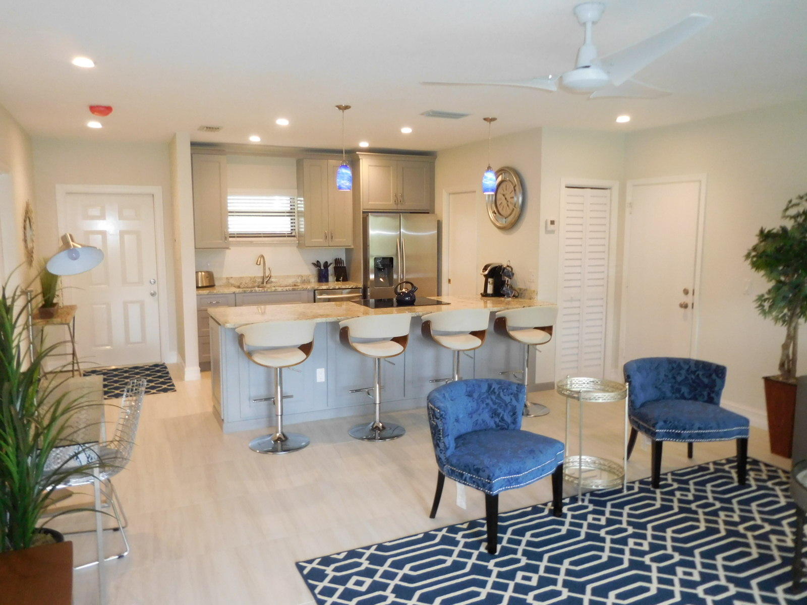 a large kitchen with a table and chairs