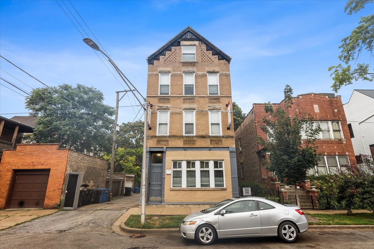 a front view of a residential apartment building with a yard