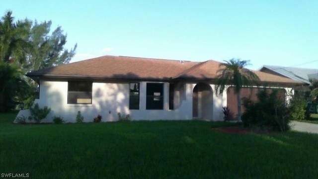 a front view of house with a garden