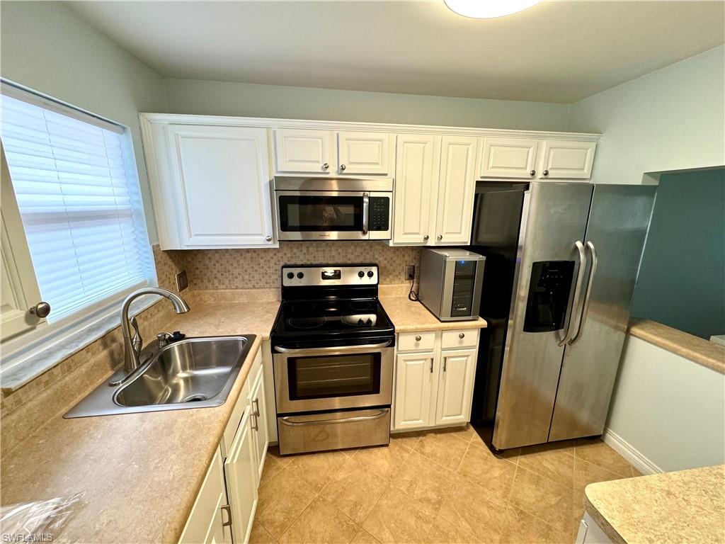 a kitchen with a sink a stove and refrigerator