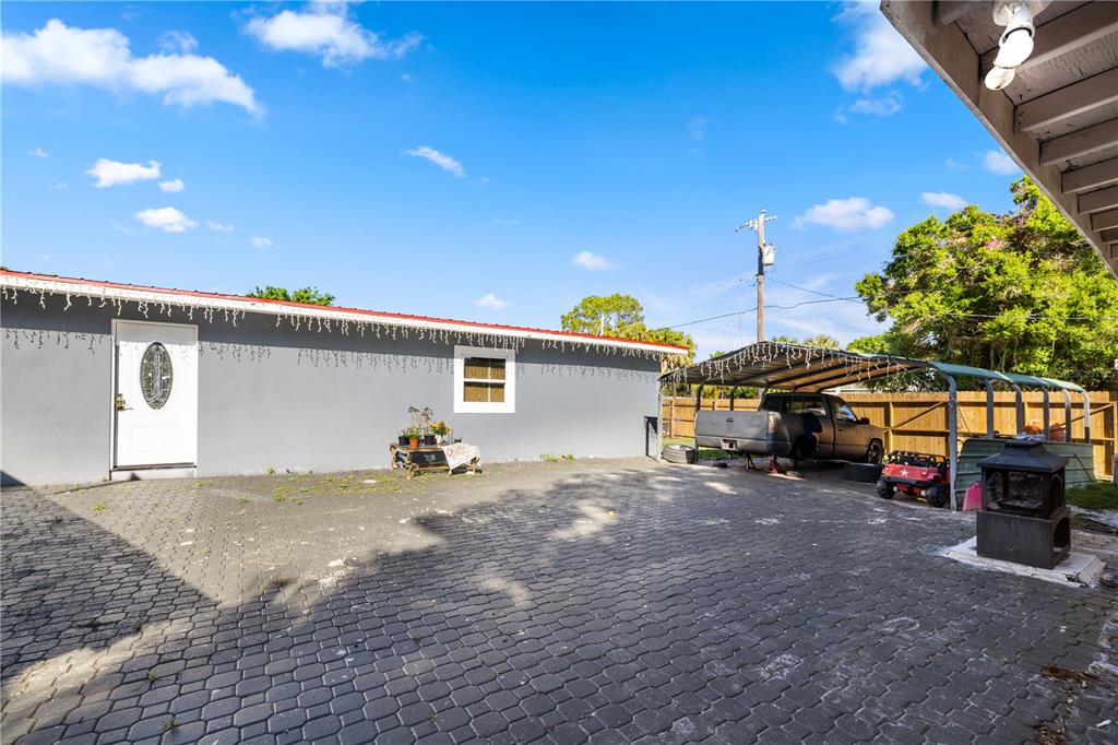 a view of a house with a yard and sitting area