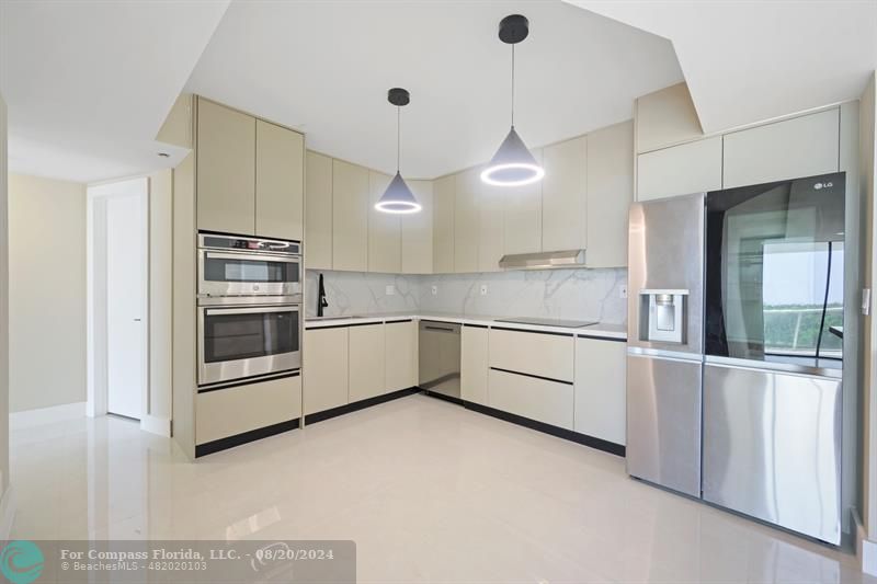 a kitchen with stainless steel appliances and white cabinets