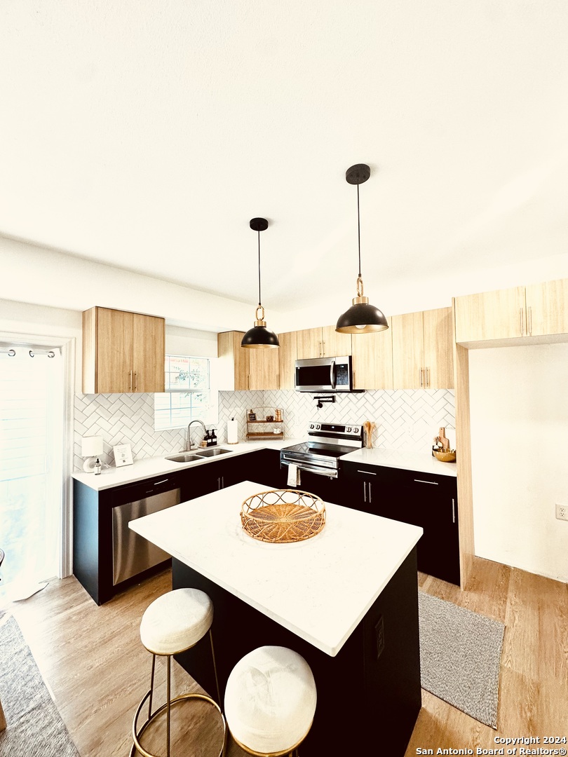 a kitchen with a table chairs sink and stove