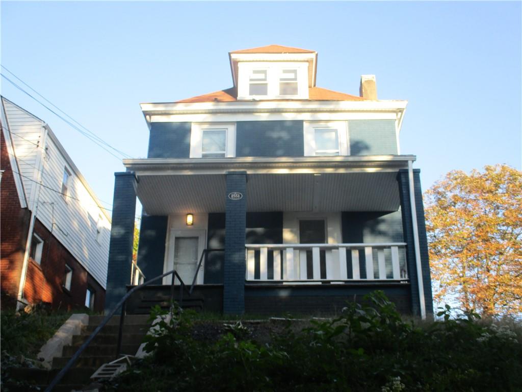 a front view of a house with plants