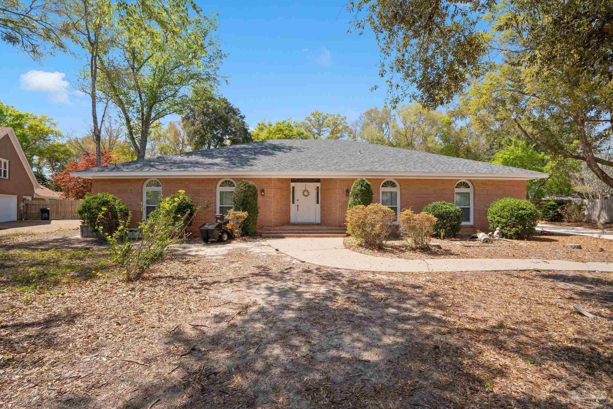 a front view of a house with garden