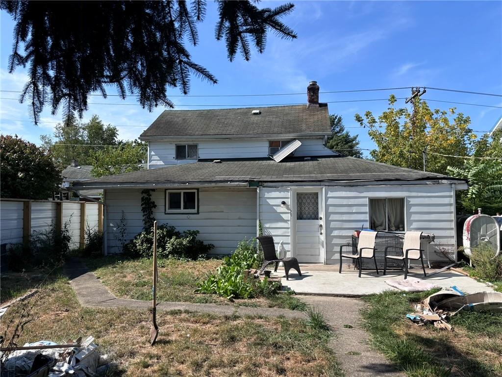 a view of a house with backyard sitting area and garden