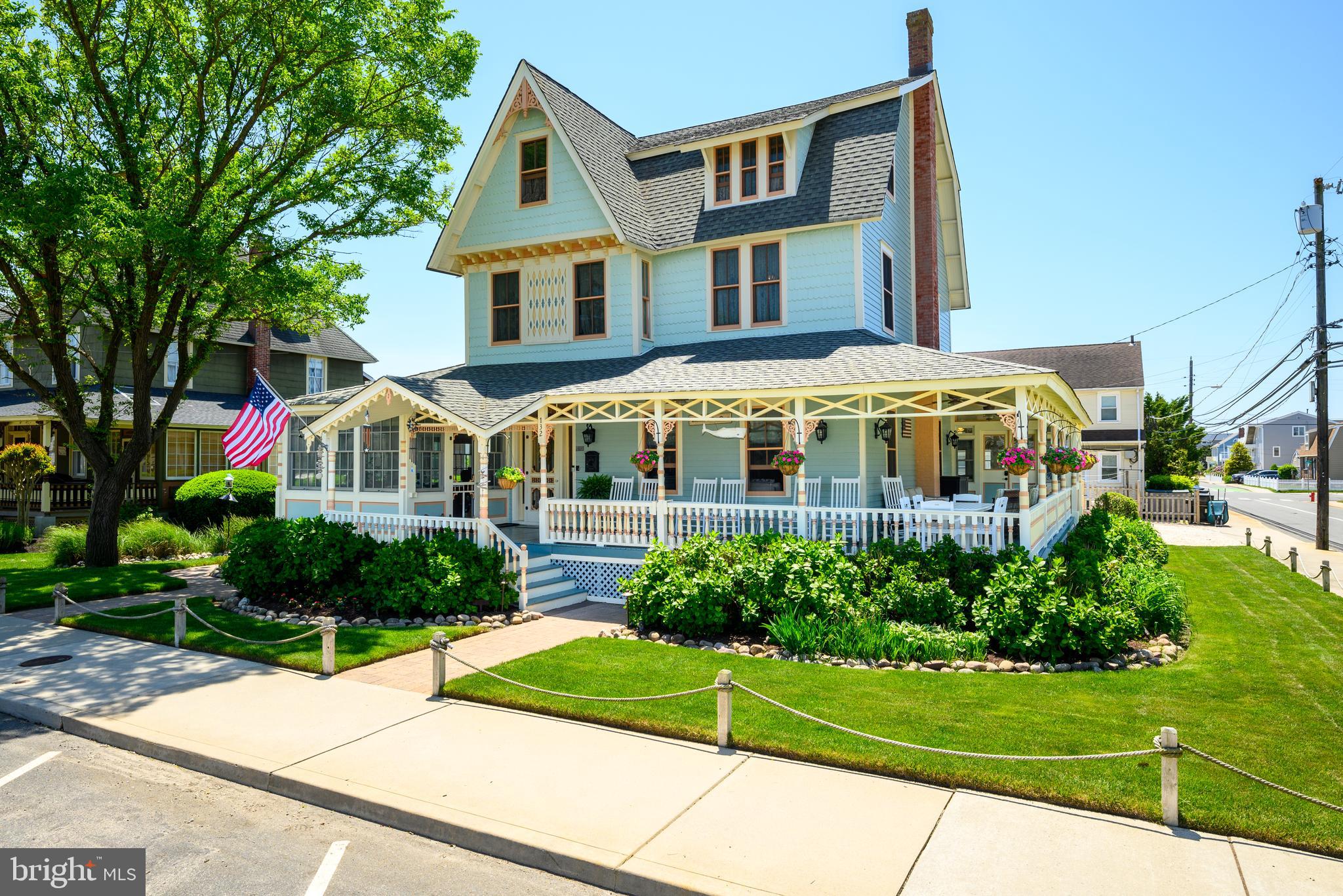 a front view of a house with a yard and potted plants