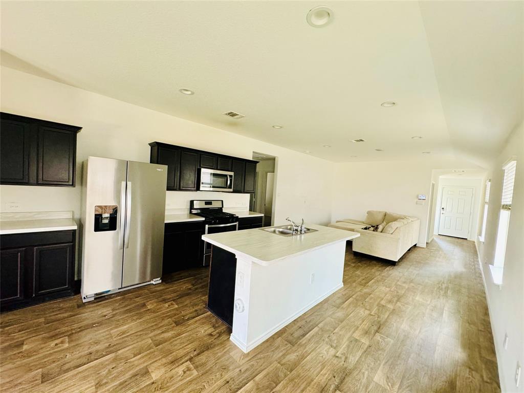 a kitchen with a sink appliances and cabinets