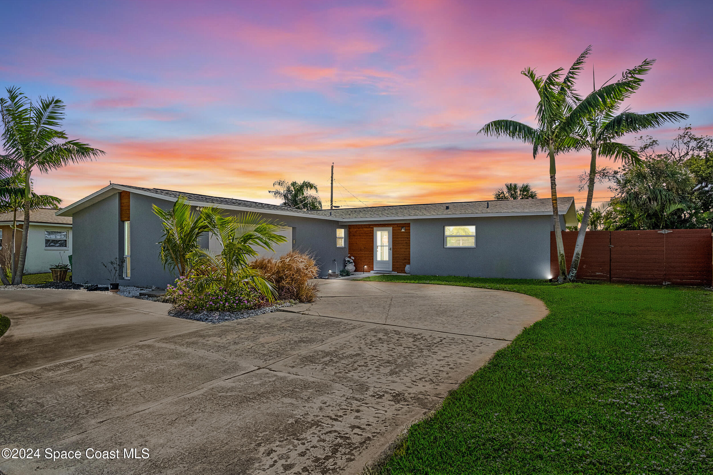 a front view of a house with a yard and a garage