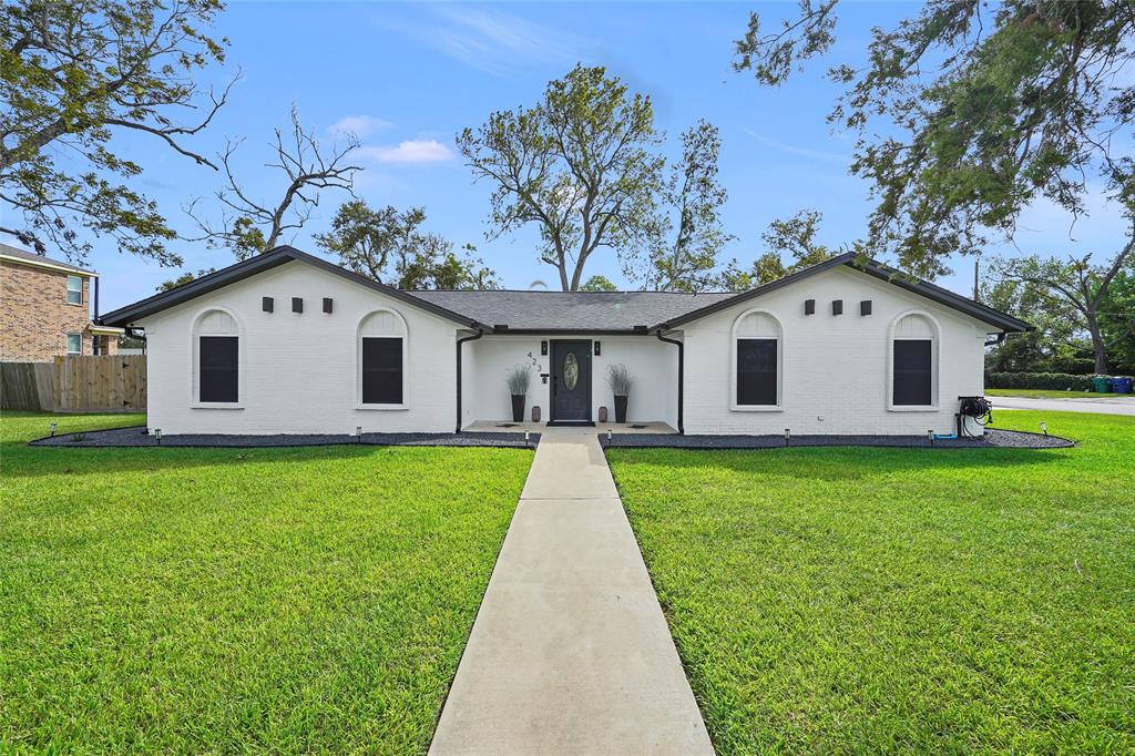 a view of white house with a yard