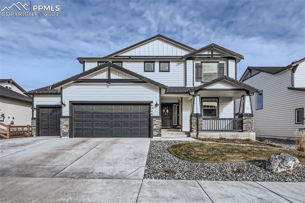 Craftsman-style home featuring a garage and covered porch