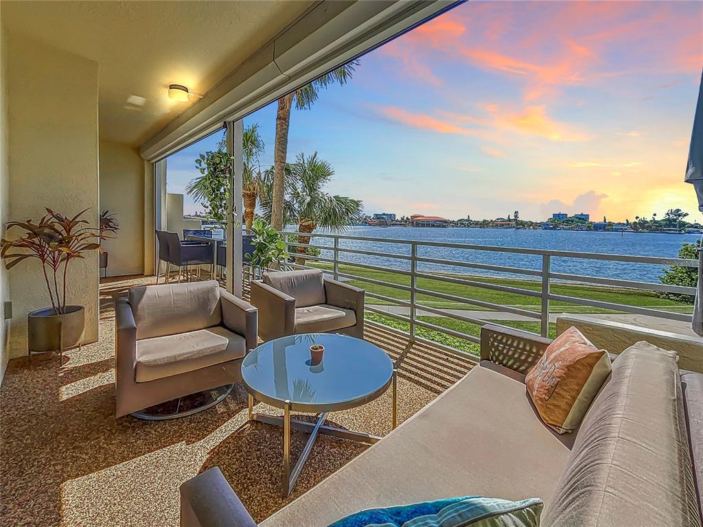 a balcony with furniture and a rug