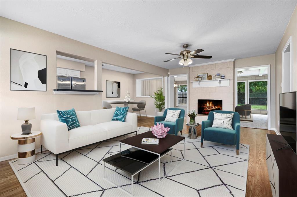 a living room with furniture a fireplace and a chandelier